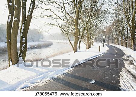 Stock Photograph - Rural road cleared of snow in winter. Fotosearch