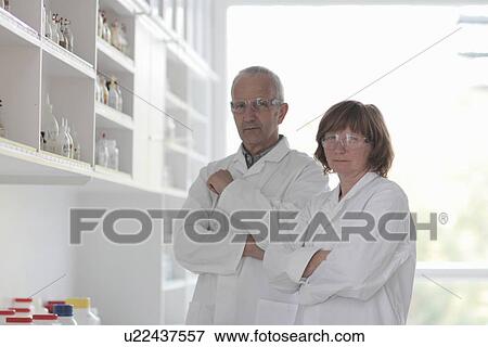 Scientists working in laboratory, arms folded View Large Photo Image Stock Photo - Scientists working in laboratory, arms folded. Fotosearch