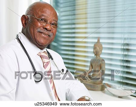 Stock Photo - Senior doctor with stethoscope, wearing lab coat. Fotosearch