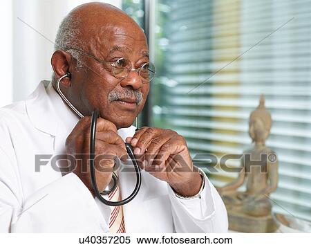 Senior doctor with stethoscope, wearing lab coat View Large Photo Image Stock Photography - Senior doctor with stethoscope, wearing lab coat. Fotosearch
