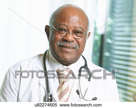 Stock Photography - Senior doctor with stethoscope, wearing lab coat. Fotosearch