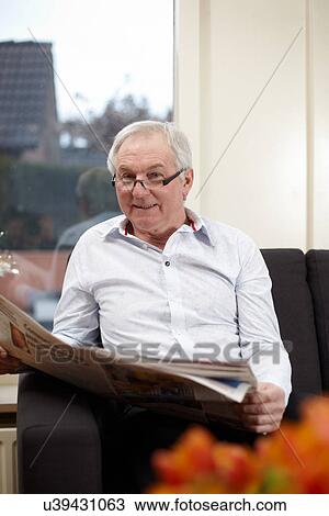 Senior man at home reading newspaper View Large Photo Image Stock Image - Senior man at home reading newspaper. Fotosearch