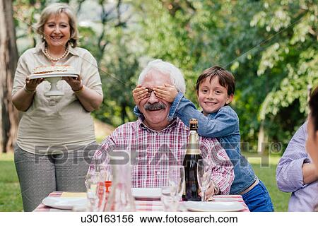 Senior man being surprised with birthday cake View Large Photo Image Stock Photograph - Senior man being surprised with birthday cake. Fotosearch