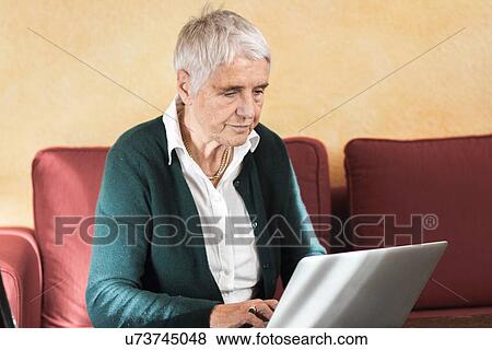 Senior woman using laptop computer View Large Photo Image Stock Photo - Senior woman using laptop computer. Fotosearch