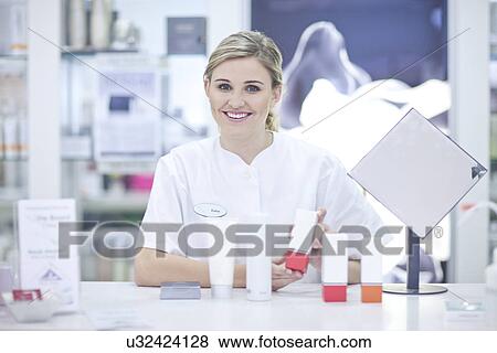 Shop assistant showing make up View Large Photo Image Stock Photo - Shop assistant showing make up. Fotosearch