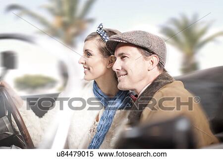 Side view of couple in convertible View Large Photo Image Stock Photography - Side view of couple in convertible. Fotosearch