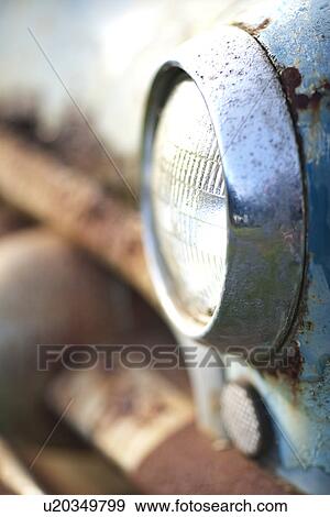 Stock Photo - Side view of rusty car headlight and bumper. Fotosearch