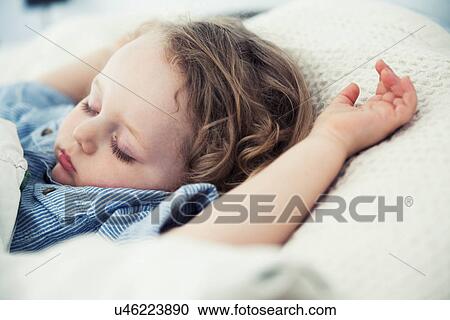 Sleeping male toddler with arms up on pillow View Large Photo Image Stock Image - Sleeping male toddler with arms up on pillow. Fotosearch