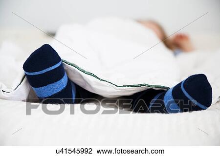 Sleeping male toddler with stripy socks View Large Photo Image Stock Image - Sleeping male toddler with stripy socks. Fotosearch