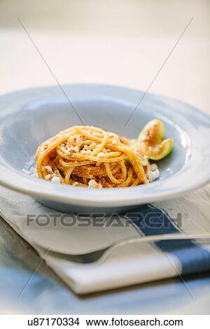 Still life of bowl of spaghetti with fig slice and parmesan View Large Photo Image Picture - Still life of bowl of spaghetti with fig slice and parmesan. Fotosearch