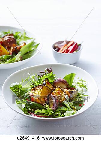 Stock Photograph - Still life of pumpkin, garlic and sesame salad. Fotosearch
