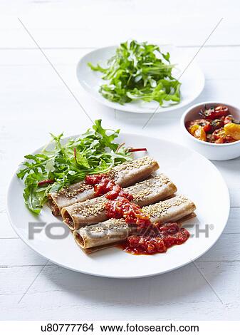 Still life of pumpkin miso cannelloni with rocket salad View Large Photo Image Picture - Still life of pumpkin miso cannelloni with rocket salad. Fotosearch