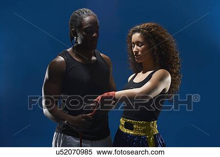 Studio portrait of female boxer and trainer preparing hand bandages View Large Photo Image Stock Photography - Studio portrait of female boxer and trainer preparing hand bandages. Fotosearch