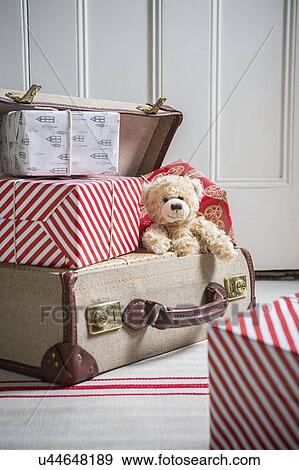 Suitcase filled with wrapped gifts and teddy bear View Large Photo Image Stock Photo - Suitcase filled with wrapped gifts and teddy bear. Fotosearch