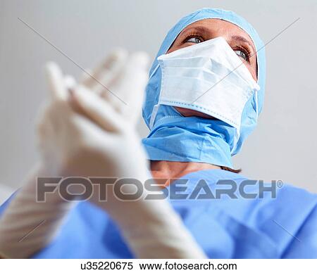 Stock Photography - Surgeon clasping hands together. Fotosearch