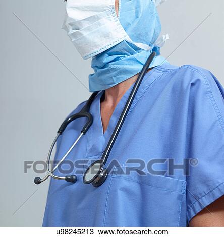 Stock Image - Surgeon wearing surgical scrubs and mask. Fotosearch