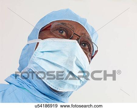 Surgeon wearing surgical scrubs and protective mask View Large Photo Image Stock Photo - Surgeon wearing surgical scrubs and protective mask. Fotosearch