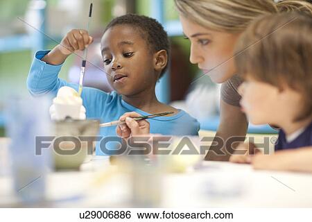Teacher and children in art class View Large Photo Image Stock Photograph - Teacher and children in art class. Fotosearch