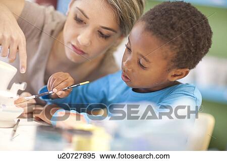 Teacher and girl in art class View Large Photo Image Stock Photography - Teacher and girl in art class. Fotosearch