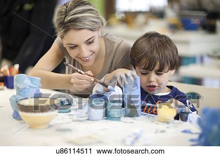 Stock Image - Teacher and toddler playing in art class. Fotosearch