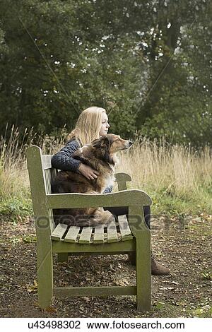 Teenage girl sitting on country bench with dog View Large Photo Image Stock Image - Teenage girl sitting on country bench with dog. Fotosearch
