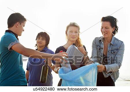 Stock Image - Teenagers collecting litter. Fotosearch