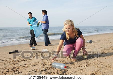 Stock Photo - Teenagers collecting litter. Fotosearch