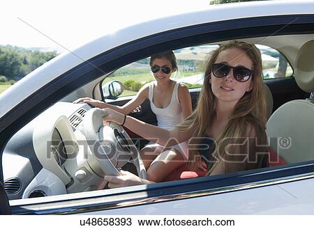 Teenagers sitting in car View Large Photo Image Stock Image - Teenagers sitting in car. Fotosearch