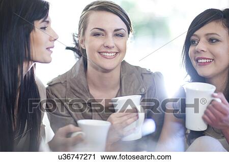 Three female friends drinking coffee View Large Photo Image Stock Image - Three female friends drinking coffee. Fotosearch
