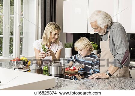 Picture - Three generation family preparing food. Fotosearch