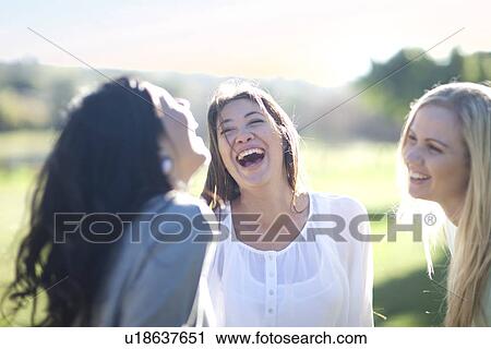 Three young women having fun in park View Large Photo Image Stock Image - Three young women having fun in park. Fotosearch