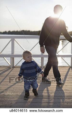 Toddler and father by lake View Large Photo Image Stock Photography - Toddler and father by lake. Fotosearch