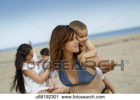 Toddler on mother's back View Large Photo Image Stock Image - Toddler on mother's back. Fotosearch