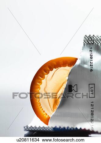 Picture - Torn packaging of wrapper containing a condom. Fotosearch