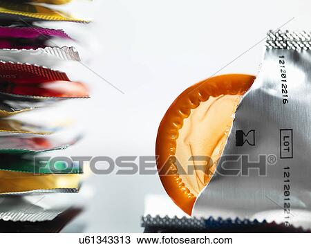 Stock Image - Torn packaging of wrapper containing a condom. Fotosearch
