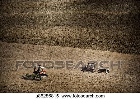 Stock Photography - Tractor in field, Siena, Valle Orcia, Tuscany, Italy. Fotosearch