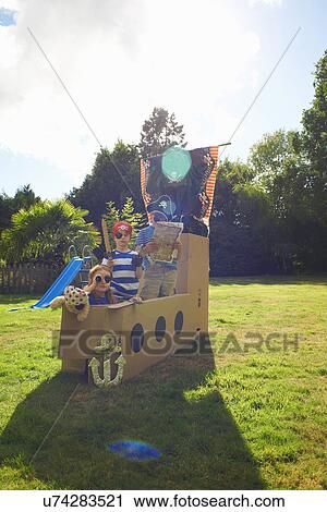 Two brothers and sister playing in garden with homemade pirate ship View Large Photo Image Stock Image - Two brothers and sister playing in garden with homemade pirate ship. Fotosearch