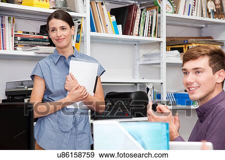 Two colleagues in office View Large Photo Image Stock Photo - Two colleagues in office. Fotosearch