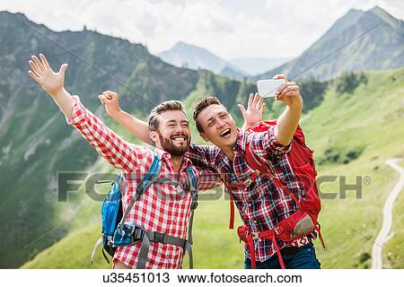 Two male friends photographing themselves, Tyrol, Austria View Large Photo Image Stock Image - Two male friends photographing themselves, Tyrol, Austria. Fotosearch