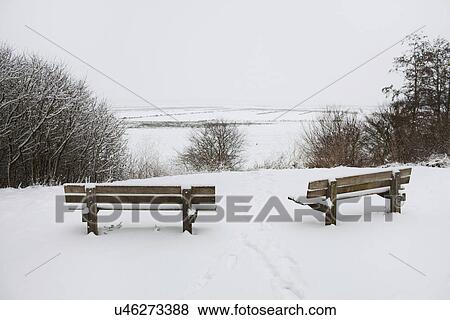 Two rural park benches looking out over snow covered view View Large Photo Image Stock Photo - Two rural park benches looking out over snow covered view. Fotosearch