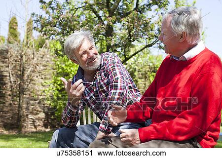 Two senior male friends tallking View Large Photo Image Stock Image - Two senior male friends tallking. Fotosearch