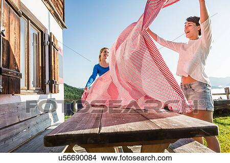 Picture - Two women preparing table, Tyrol, Austria. Fotosearch