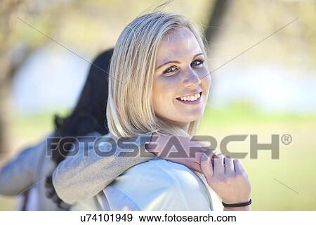 Stock Photo - Two young women strolling in park. Fotosearch