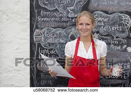 Waitress holding jar of chalk and menu in cafe View Large Photo Image Stock Image - Waitress holding jar of chalk and menu in cafe. Fotosearch