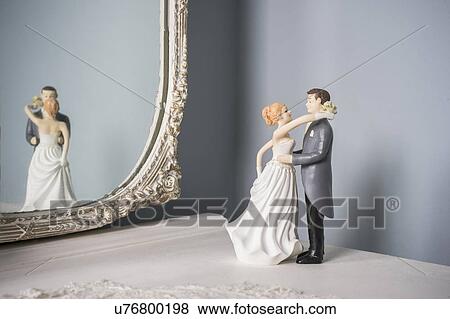 Stock Photo - Wedding figurines and wall mirror. Fotosearch