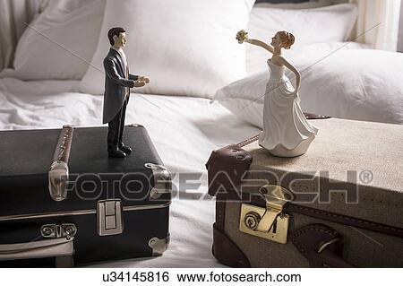 Wedding figurines on separate suitcases View Large Photo Image Stock Photograph - Wedding figurines on separate suitcases. Fotosearch