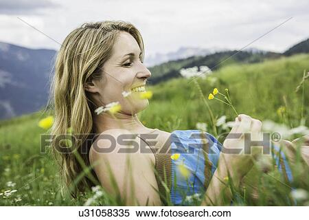 Stock Photography - Woman enjoying the meadow. Fotosearch
