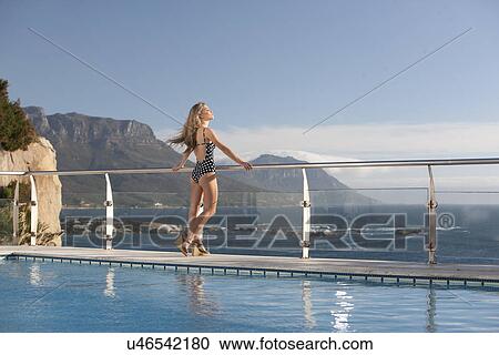 Woman enjoying view by swimming pool, Cape Town, South Africa View Large Photo Image Stock Image - Woman enjoying view by swimming pool, Cape Town, South Africa. Fotosearch