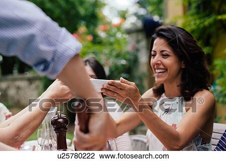 Woman holding bowl of food at outdoor meal View Large Photo Image Stock Image - Woman holding bowl of food at outdoor meal. Fotosearch