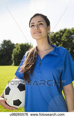 Woman holding soccer ball View Large Photo Image Stock Photograph - Woman holding soccer ball. Fotosearch